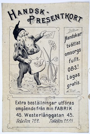 Reklamkort tryckt i svart med bild på en tomte med postsäck samt text.