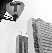 T-baneskylt vid hörnet Sveavägen - Kungsgatan. I bakgrunden Första och Andra höghusen
