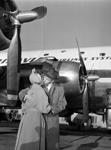 Bromma flygplats. Radioprogrammet Karusellens ""jorden-runt-flygare"" Birger Gannå kysser sin fru Doris farväl inför avresan till första etappen - New York
