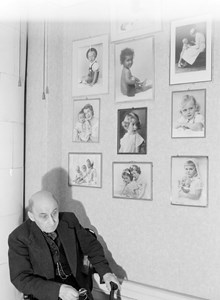 Drottninggatan 41. Fotograf Julius Grape i sin ateljé. Barnporträtt på väggen