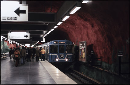 Ett tunnelbanetåg har stannat till vid perrongen vid den vackra grottväggen i rött år 1975.