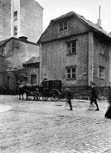 Linnégatan österut från Jungfrugatan. Ett fordon draget av två hästar står vid Linnégatan 36. Huset revs 1905