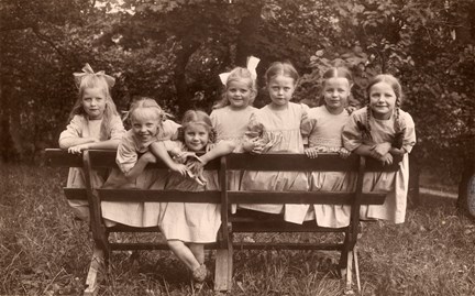 Svartvitt fotografi på flickor på en parkbänk från Frimurarbarnhuset