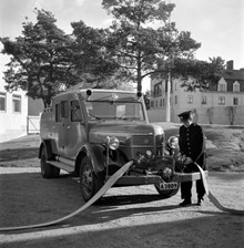 Brandbil med motorspruta år 1945 vid Brännkyrka brandstation. I fonden skymtar kvarteret Järneken.