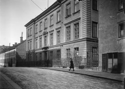 Svartvit bild från vykort med texten Stockholm, Separator nedtill. I bakgrunden en stor byggnad och i förgrunden ett trettiotal arbetarmän som tittar mot kameran.