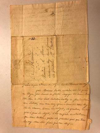 Gulnat brev med handskriven text på franska. En sida av brevet som har tre vikningar, i mitten finns adressaten och i nedre delen sidan 3 i brevet.